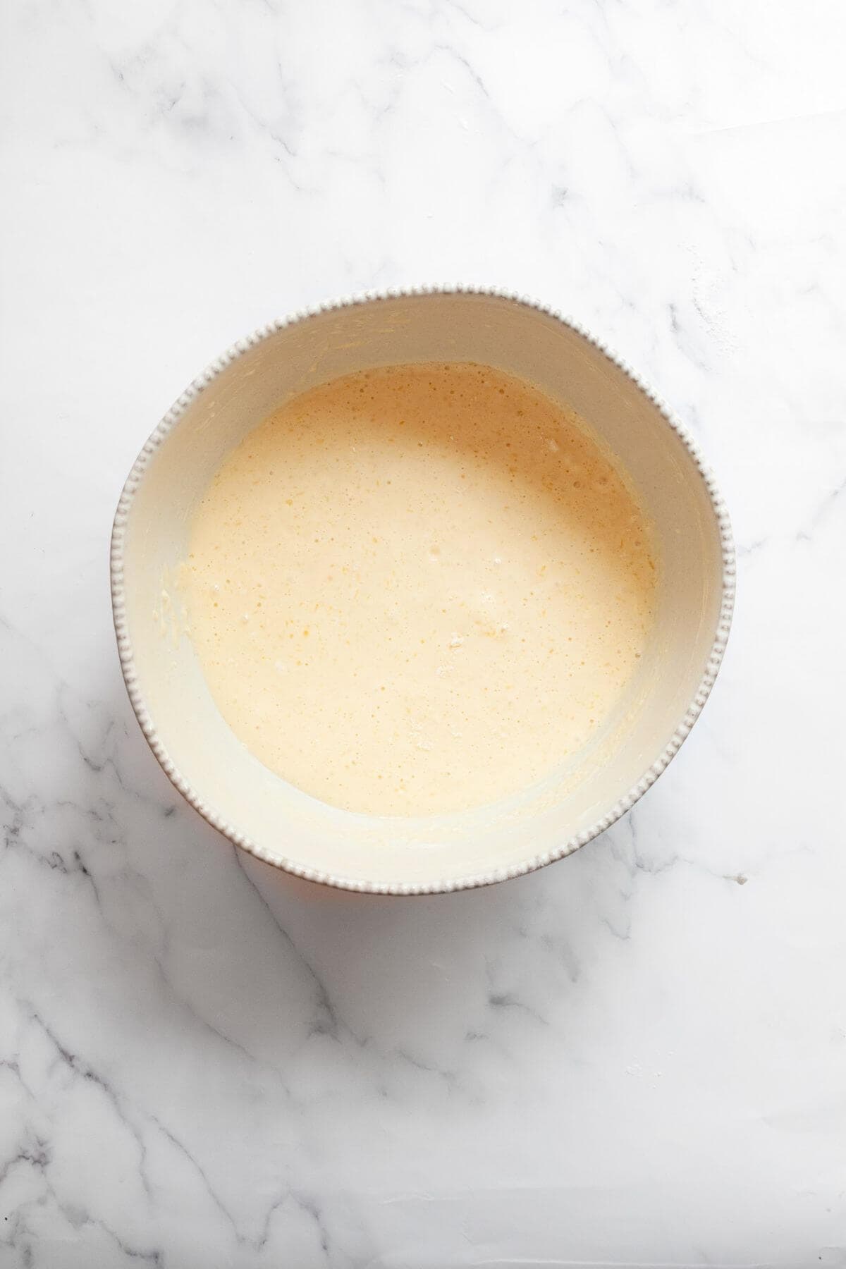 Smooth dairy-free waffle batter in a bowl.