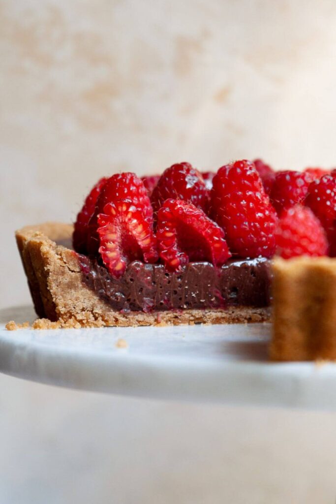 inside shot of chocolate raspberry tart with a no-bake dark chocolate filling