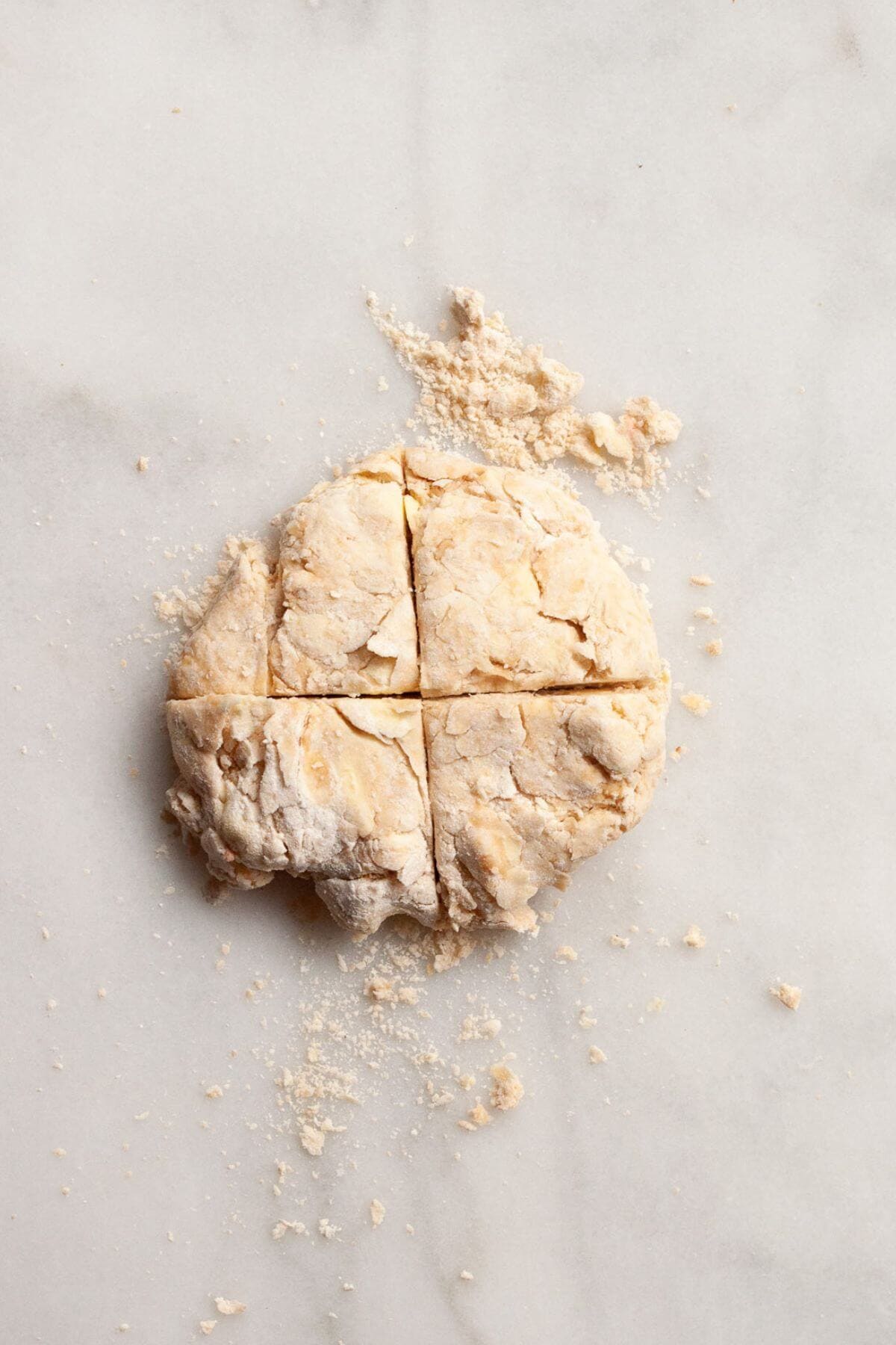 Shaggy gluten-free biscuit dough cut into quarters before laminating.