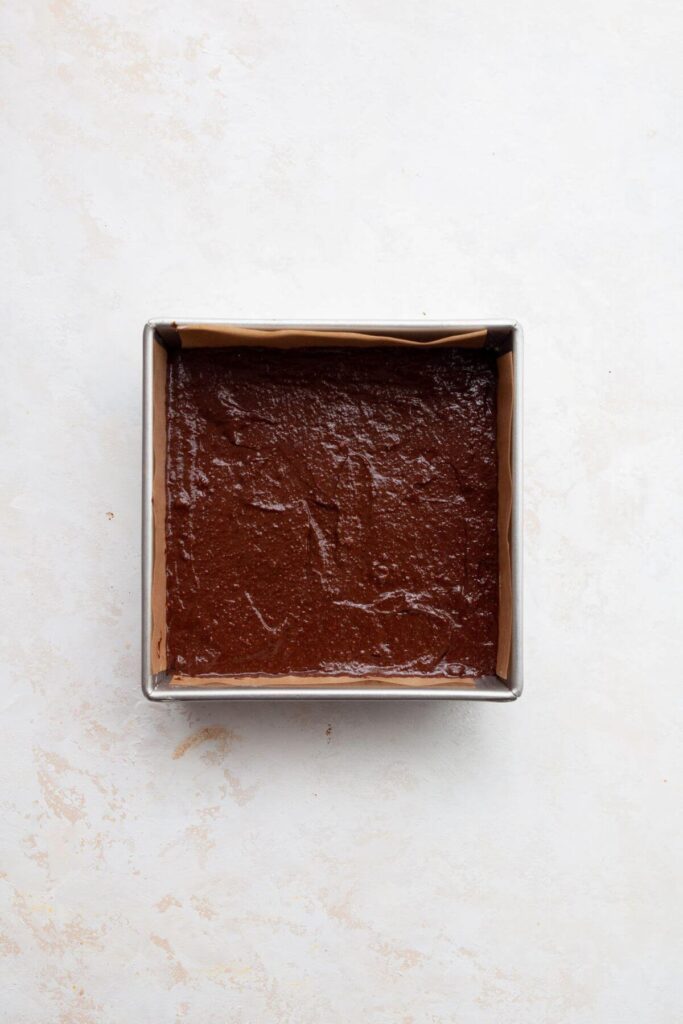 brownie batter in a baking tin before baking