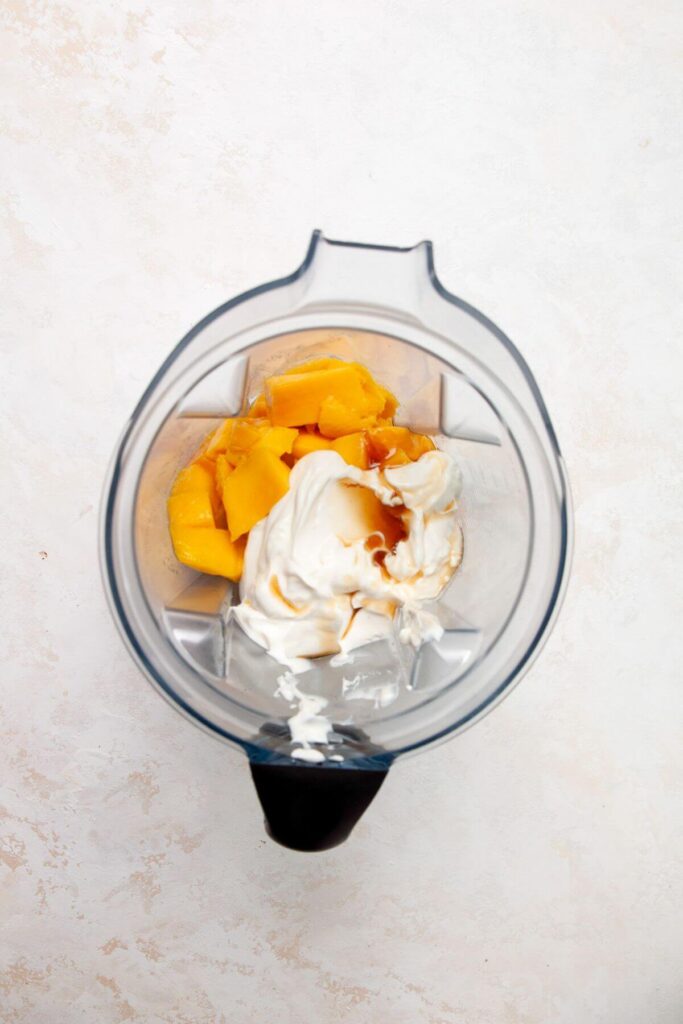 fresh mango, greek yogurt, and maple syrup in a blender