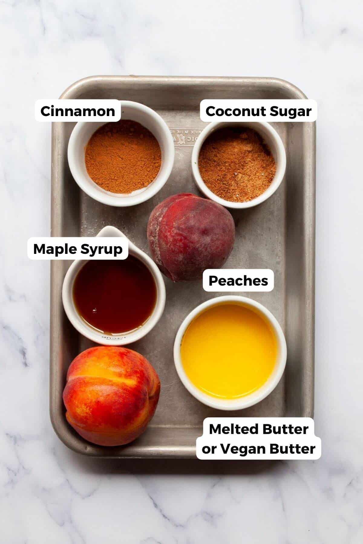 All ingredients in air fryer peaches recipe, including fresh peaches, melted butter, maple syrup, coconut sugar, and cinnamon.