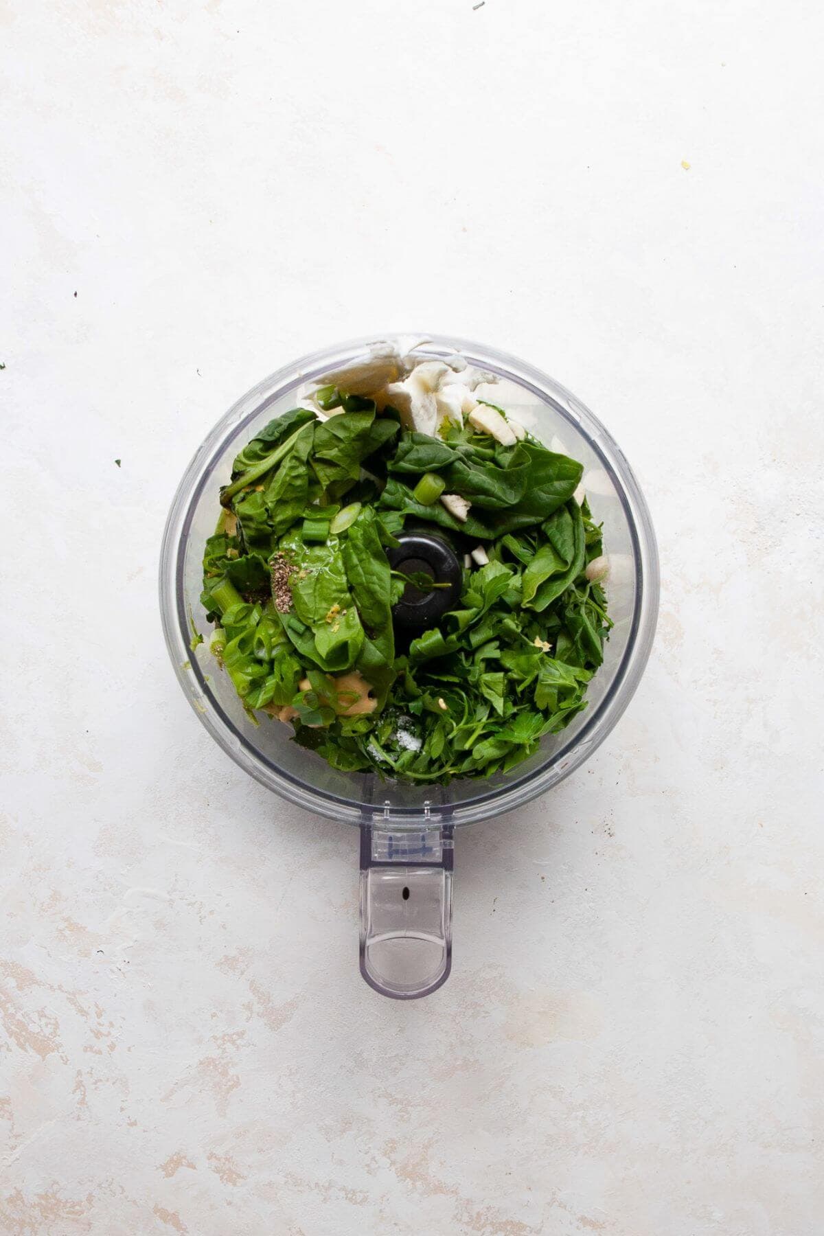 Whole ingredients added to a food processor before blending the dressing.