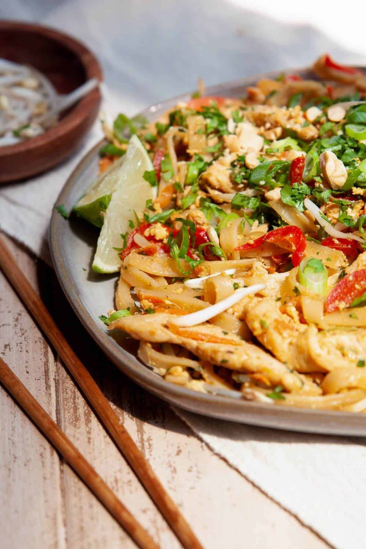 Healthy chicken pad Thai with chewy rice noodles, juicy chicken, and a tangy-sweet sauce.