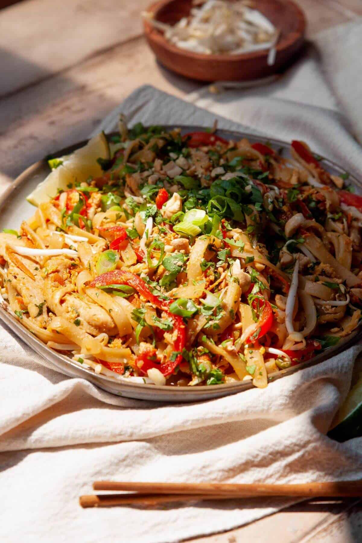 Sugar-free homemade chicken pad Thai with rice noodles, chicken, vegetables, and fresh cilantro.