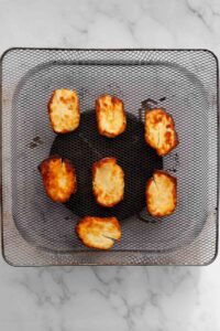 crispy air fried halloumi cheese in the an air fryer basket