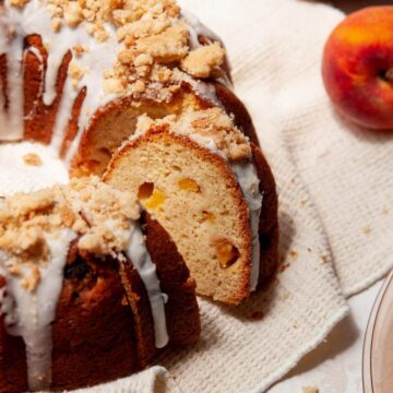 peach cobbler pound cake with icing and a buttery streusel