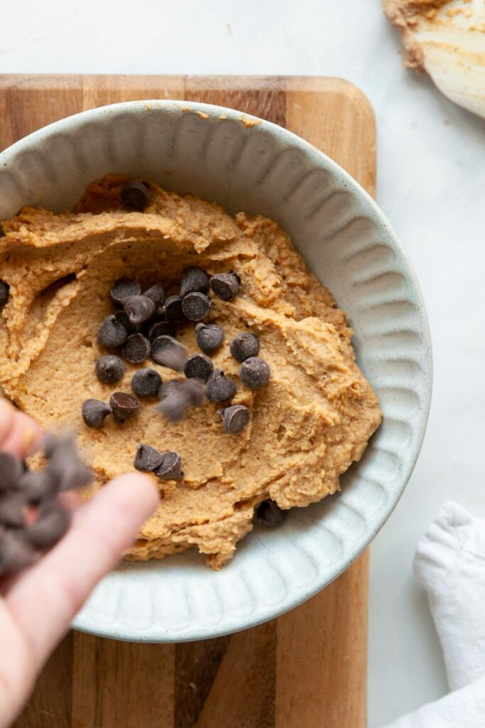 chickpea cookies dough in a bowl with chocolate chips