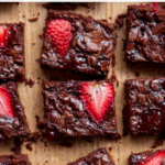 This super fudgy and rich double chocolate strawberry brownies recipe has crispy edges and gooey middles. They're made with fresh strawberries, maple syrup, and real chocolate. The easiest and best homemade brownie recipe!
