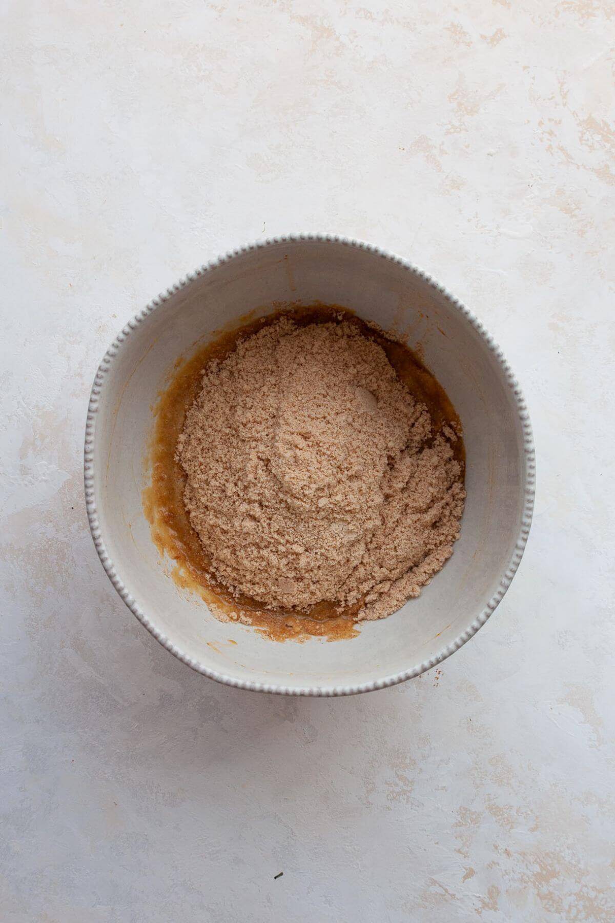 Wet ingredients for almond flour coffee cake mixed together in a bowl.