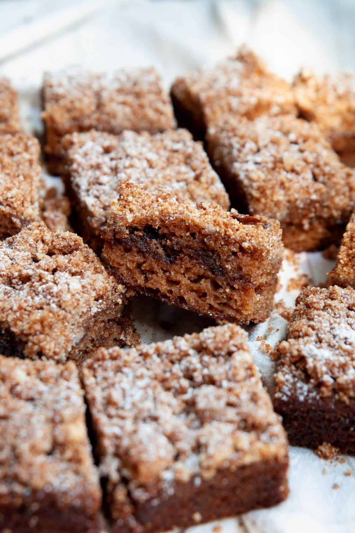 Healthy almond flour coffee cake sliced into squares with cinnamon swirl and crumb topping.