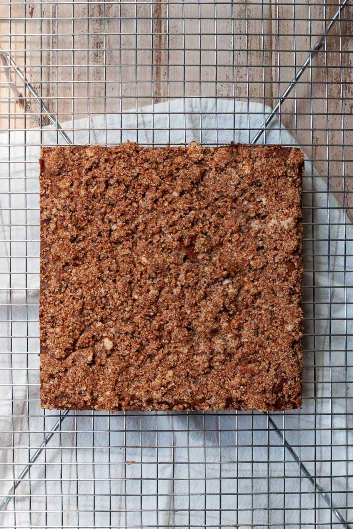 Baked healthy coffee cake with golden crumb topping and cinnamon swirl center.