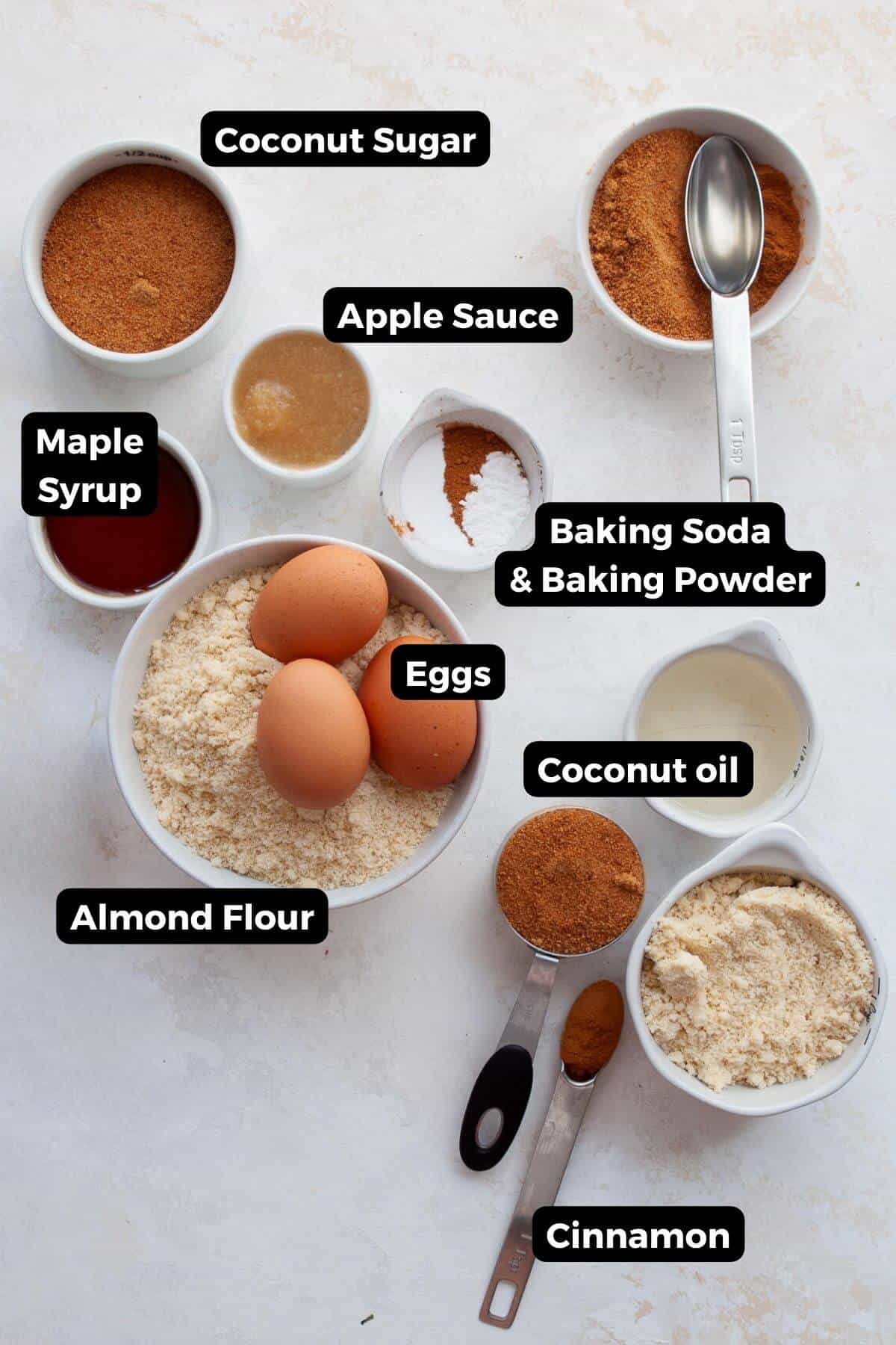 Ingredients for healthy coffee cake including almond flour, eggs, applesauce, maple syrup, and cinnamon.
