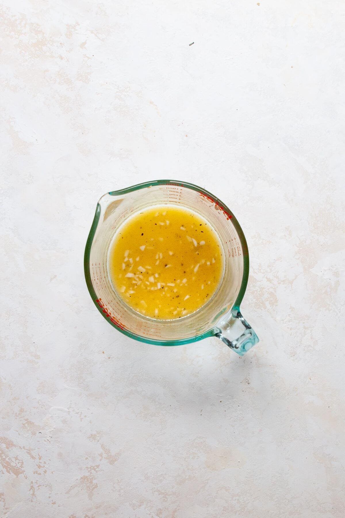 homemade healthy apple cider vinaigrette in a measuring cup