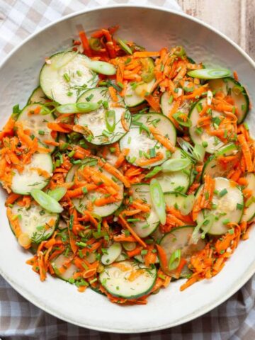 Simple Italian carrot and cucumber salad tossed in a light apple cider vinaigrette with chives and green onion.