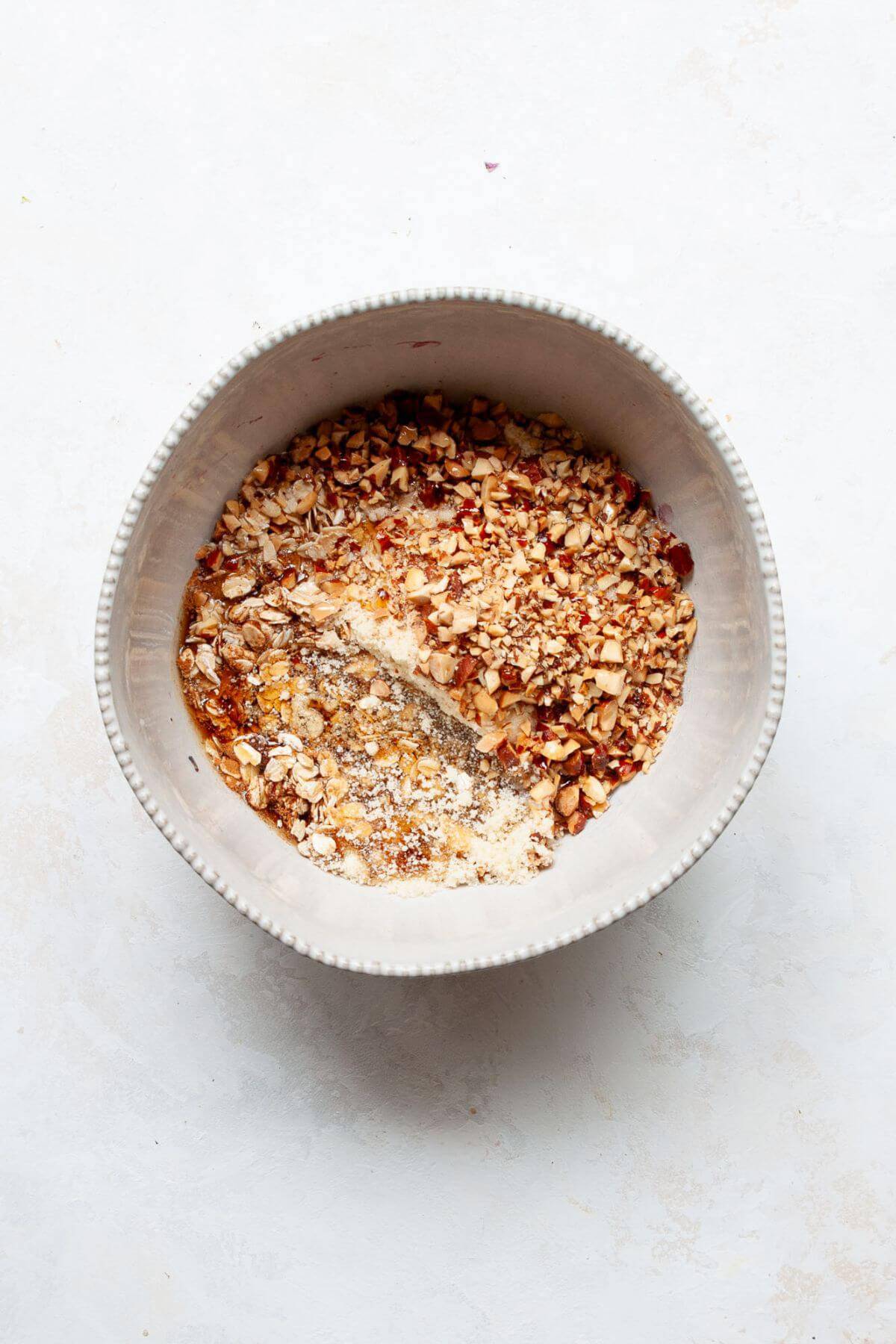 Gluten-free almond-oat crumble topping mixed with rolled oats, almond flour, and chopped walnuts.