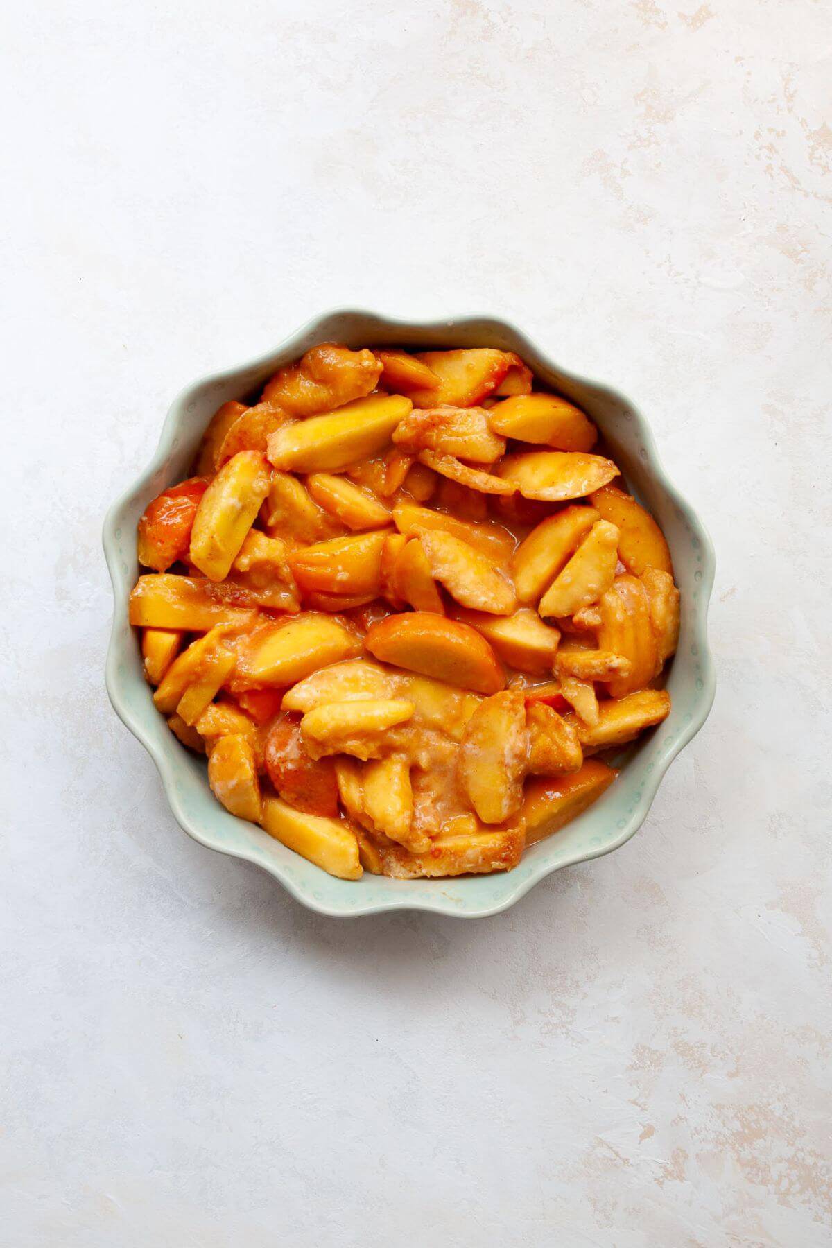 Peach filling in pie dish.