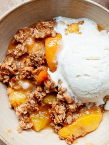 Healthy peach crisp with jammy peaches and crispy, gluten-free oat crumble topping.