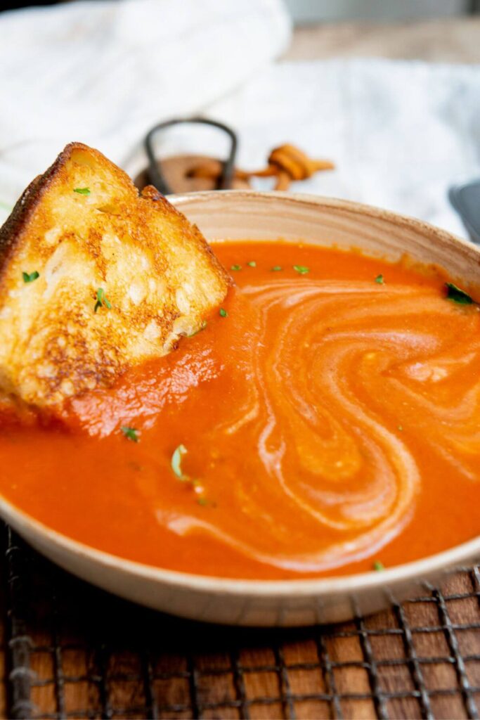 creamy tomato soup with a swirl of coconut milk on top