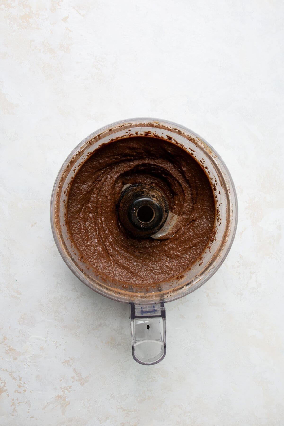 Chickpea brownie batter blended smooth in a food processor.