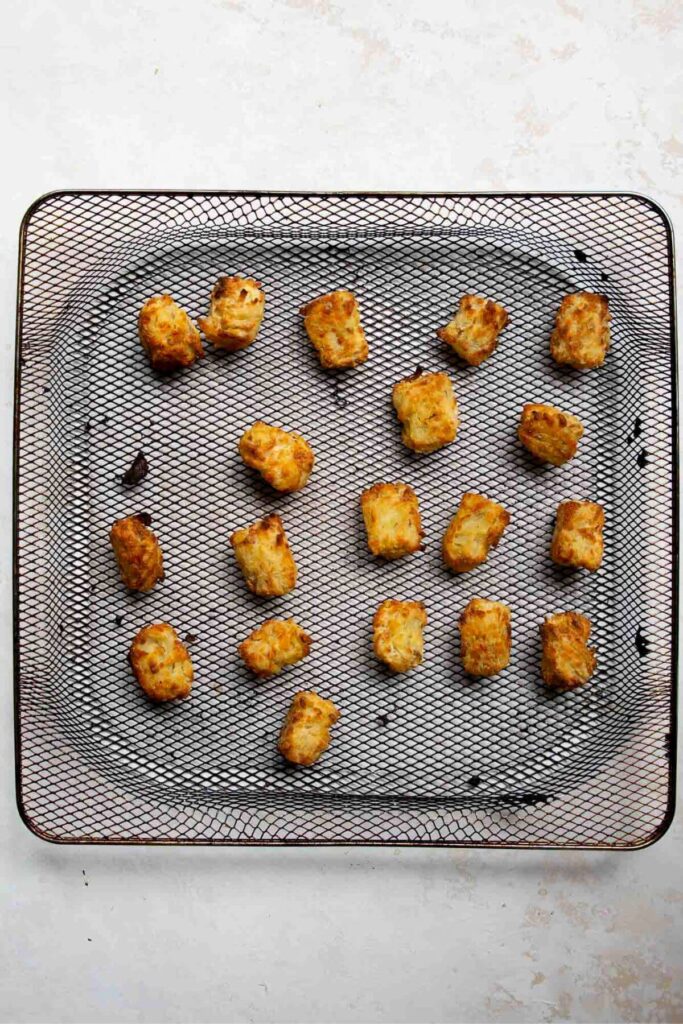 crispy and golden tater tots in an air fryer basket