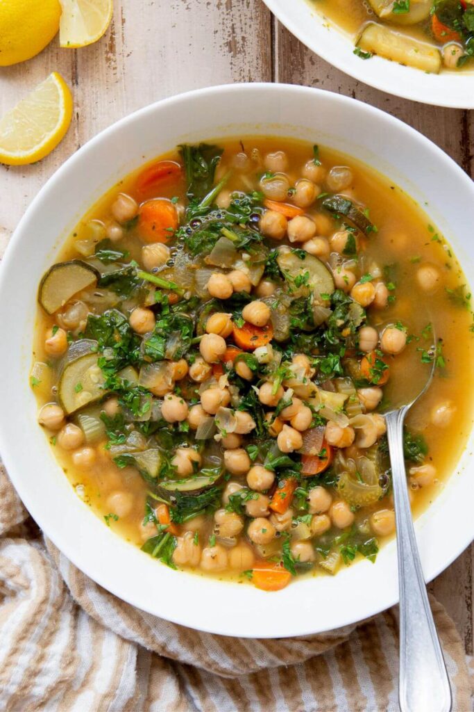 lemony Greek chickpea soup in a bowl with a spoon