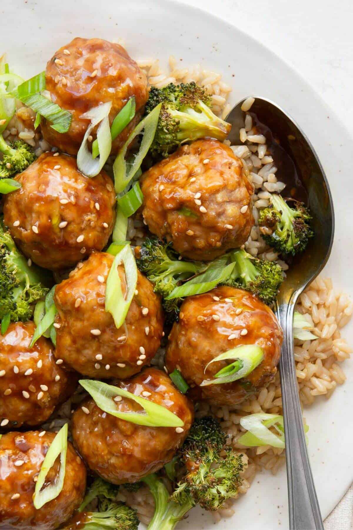Healthy teriyaki turkey meatballs with brown rice and roasted broccoli.