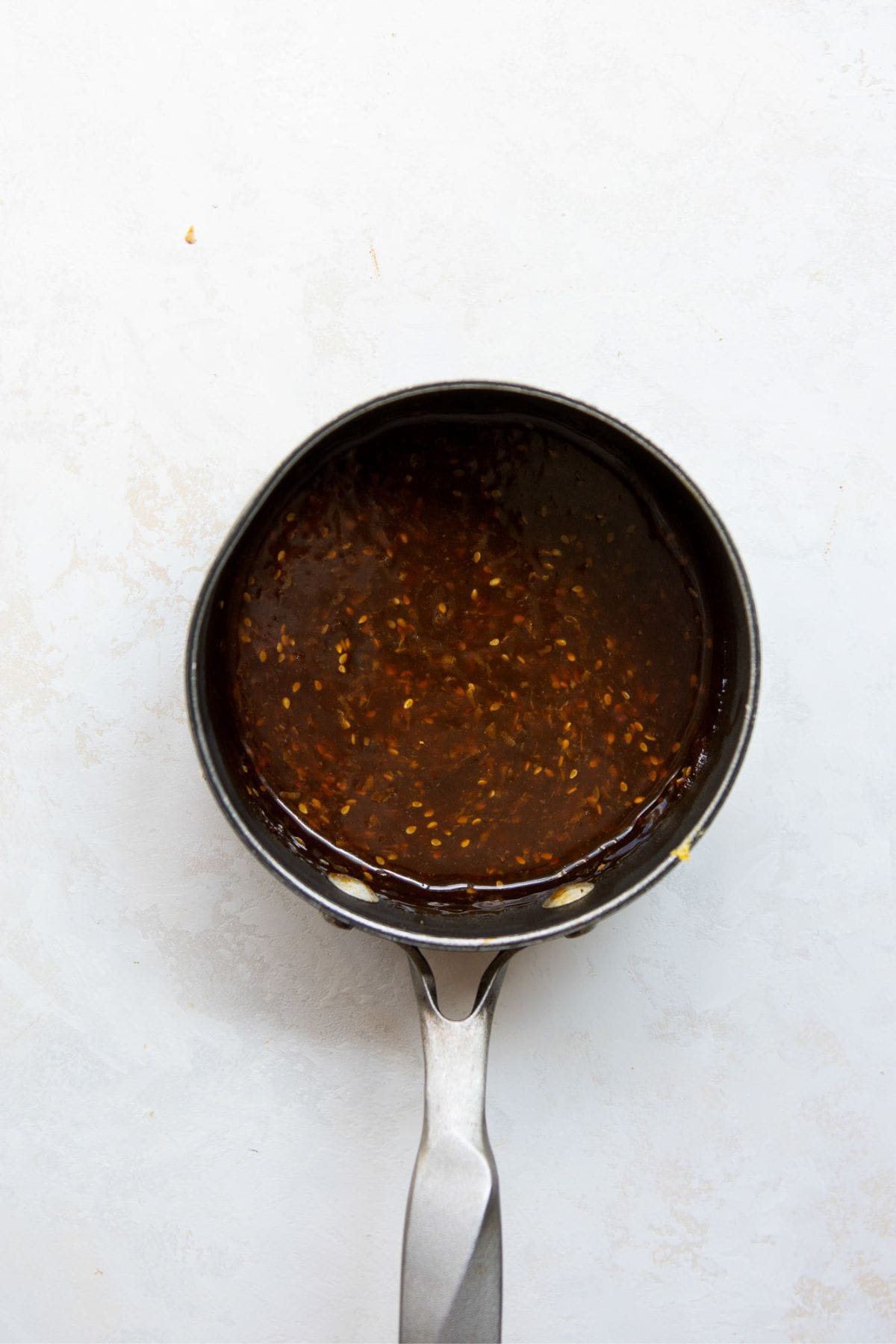 Sticky homemade teriyaki sauce made with honey in a sauce pan.