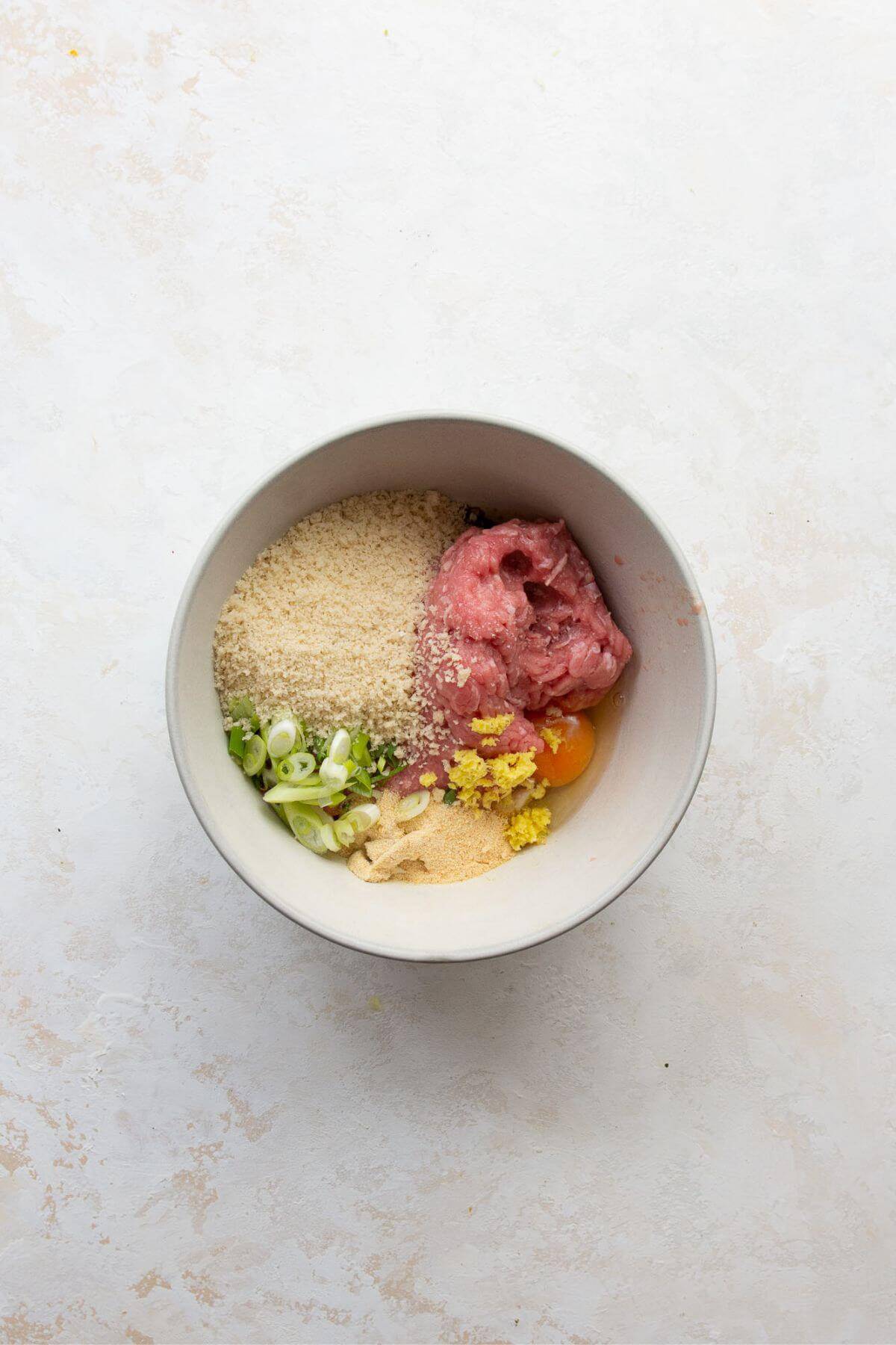 All ingredients for turkey meatball mixture in a small bowl before mixing.