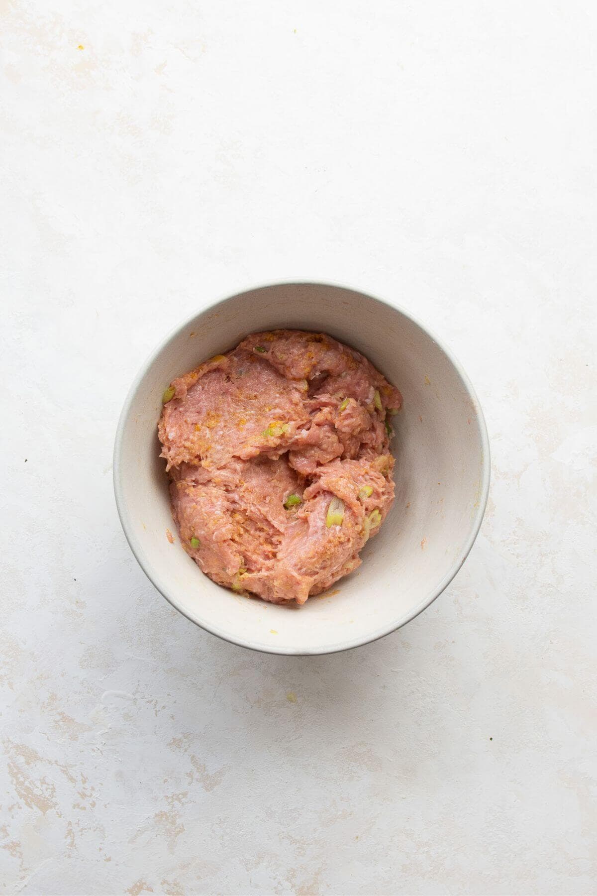 Asian turkey meatball mixture in a mixing bowl.