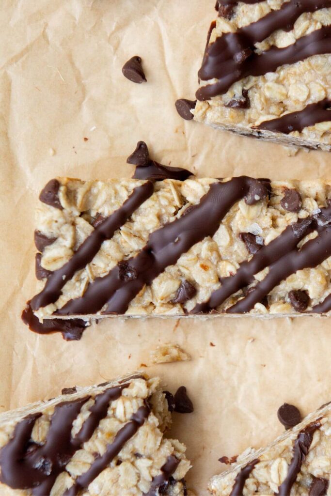 close up of chocolate drizzled on top of a chewy oatmeal bar