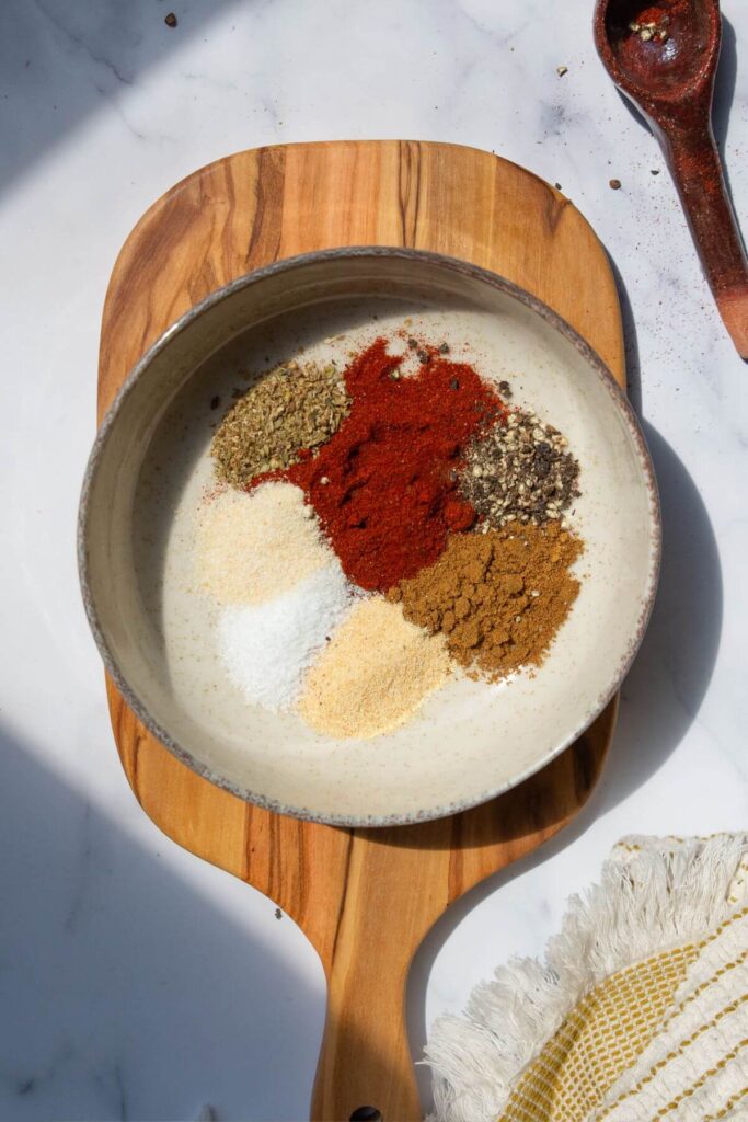 all spices sectioned in a bowl before mixing