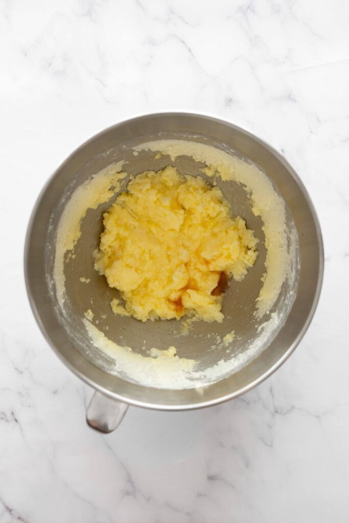 adding an egg to whipped butter and sugar