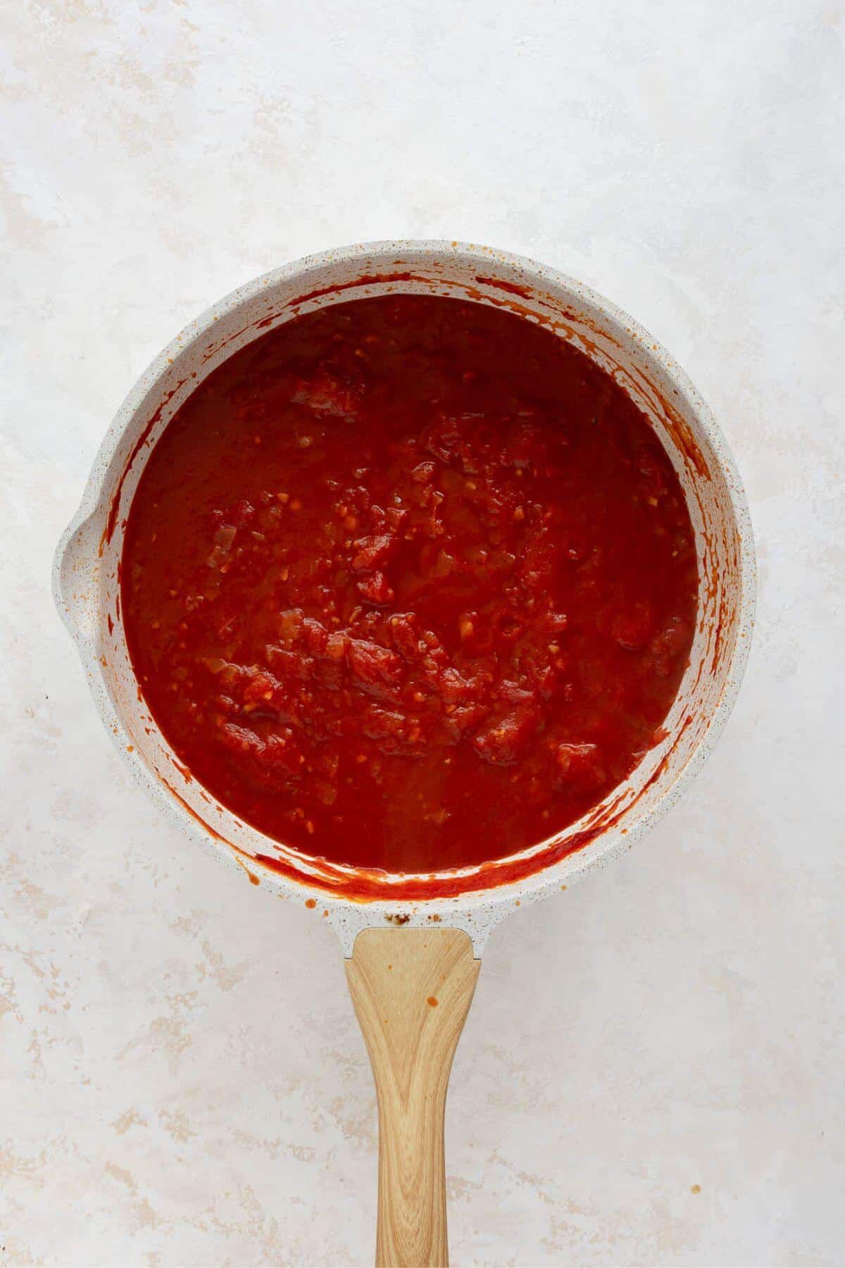 Crushed tomato vodka sauce simmering in a large pan before adding Greek yogurt.