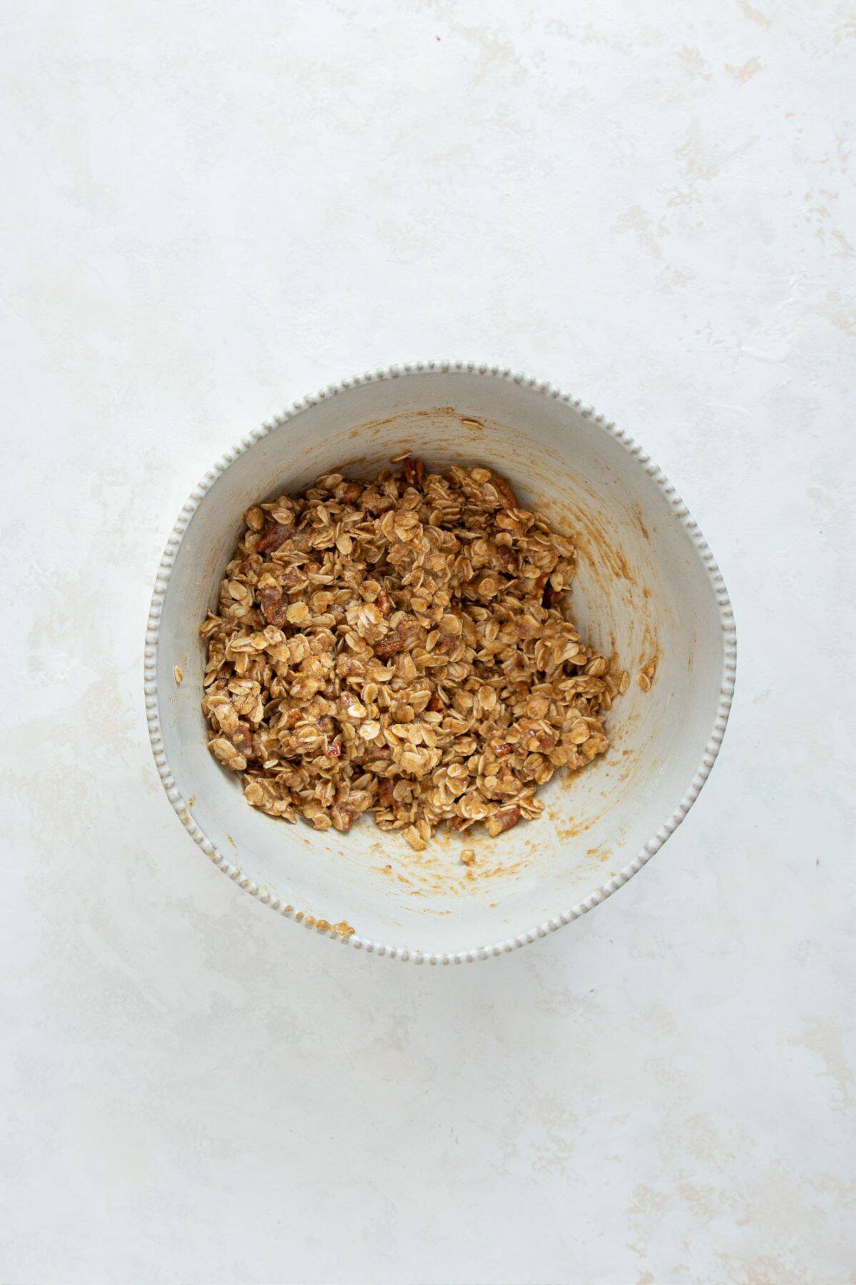 Oat and oat flour crumble topping mixed together in a bowl.