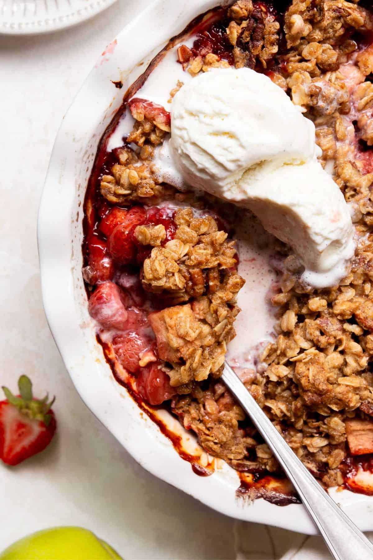 Healthy strawberry apple crumble with vanilla ice cream.