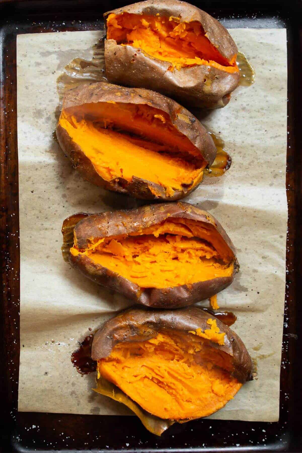 Four baked sweet potatoes cut open for taco stuffed sweet potatoes.