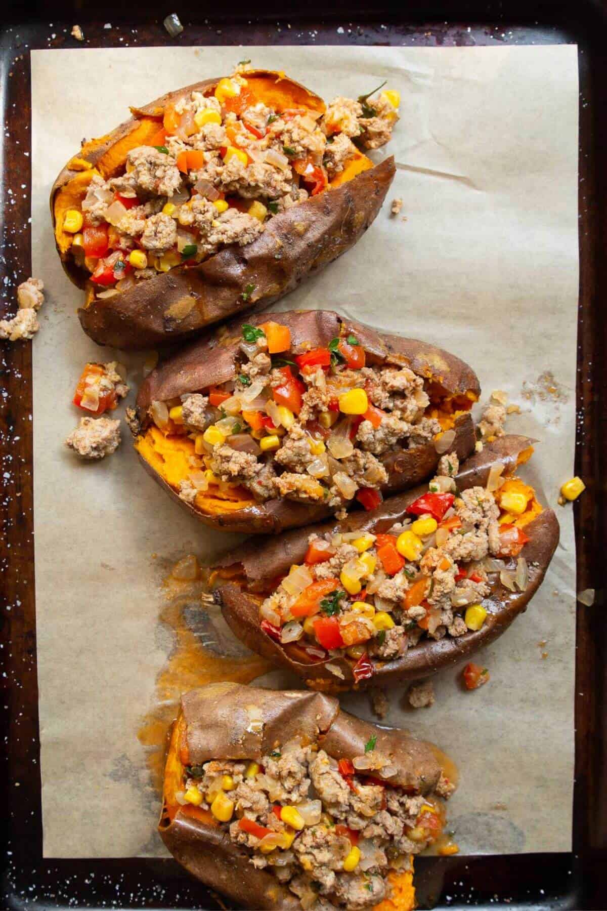 Filling sweet potatoes with saucy ground turkey taco mixture.