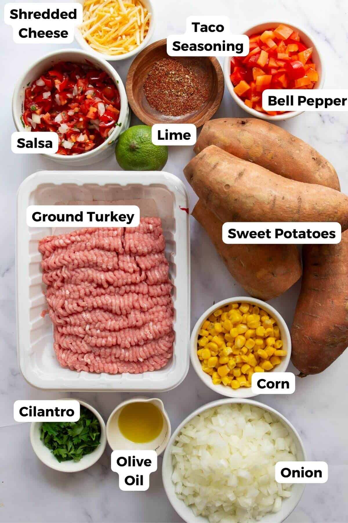 All ingredients for turkey taco stuffed sweet potatoes including ground turkey, sweet potatoes, salsa, corn, and bell pepper.