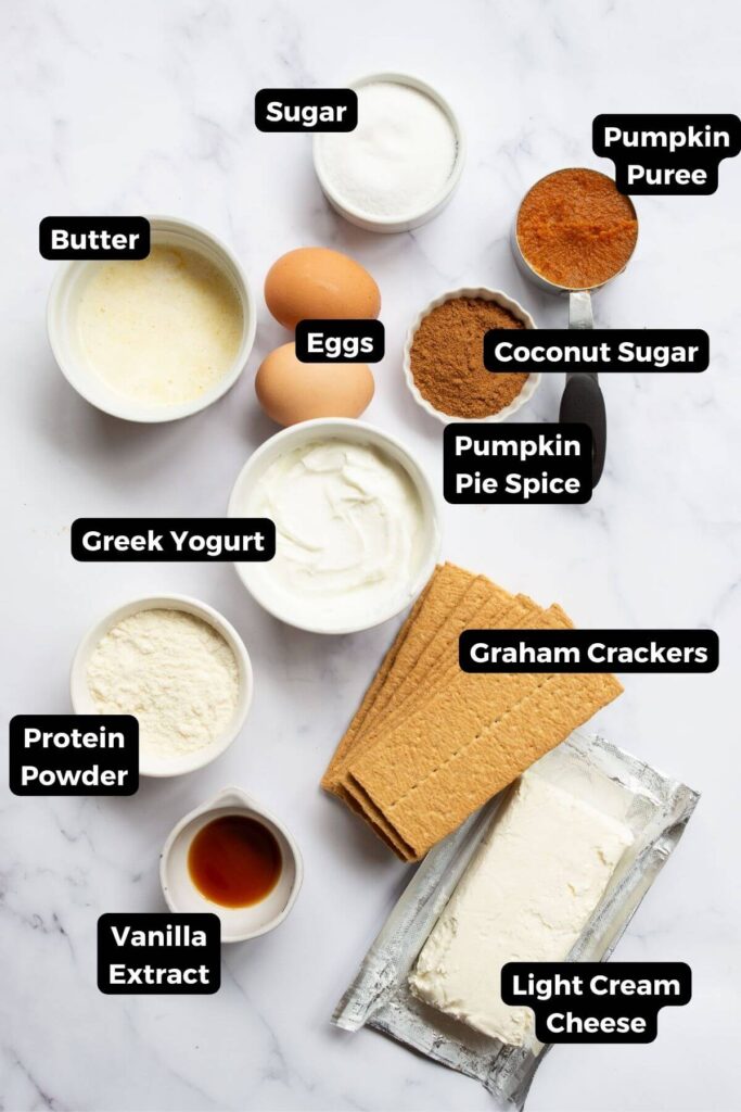 all ingredients in mini protein pumpkin cheesecakes in small bowls with labels