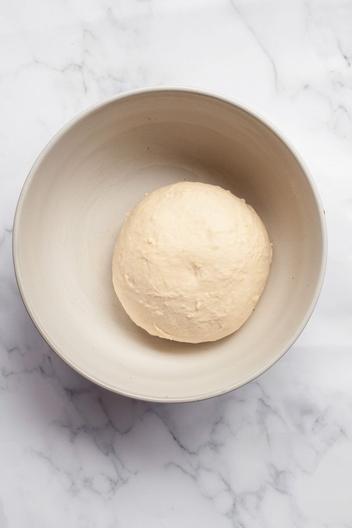 Monkey bread dough before rising in a bowl.