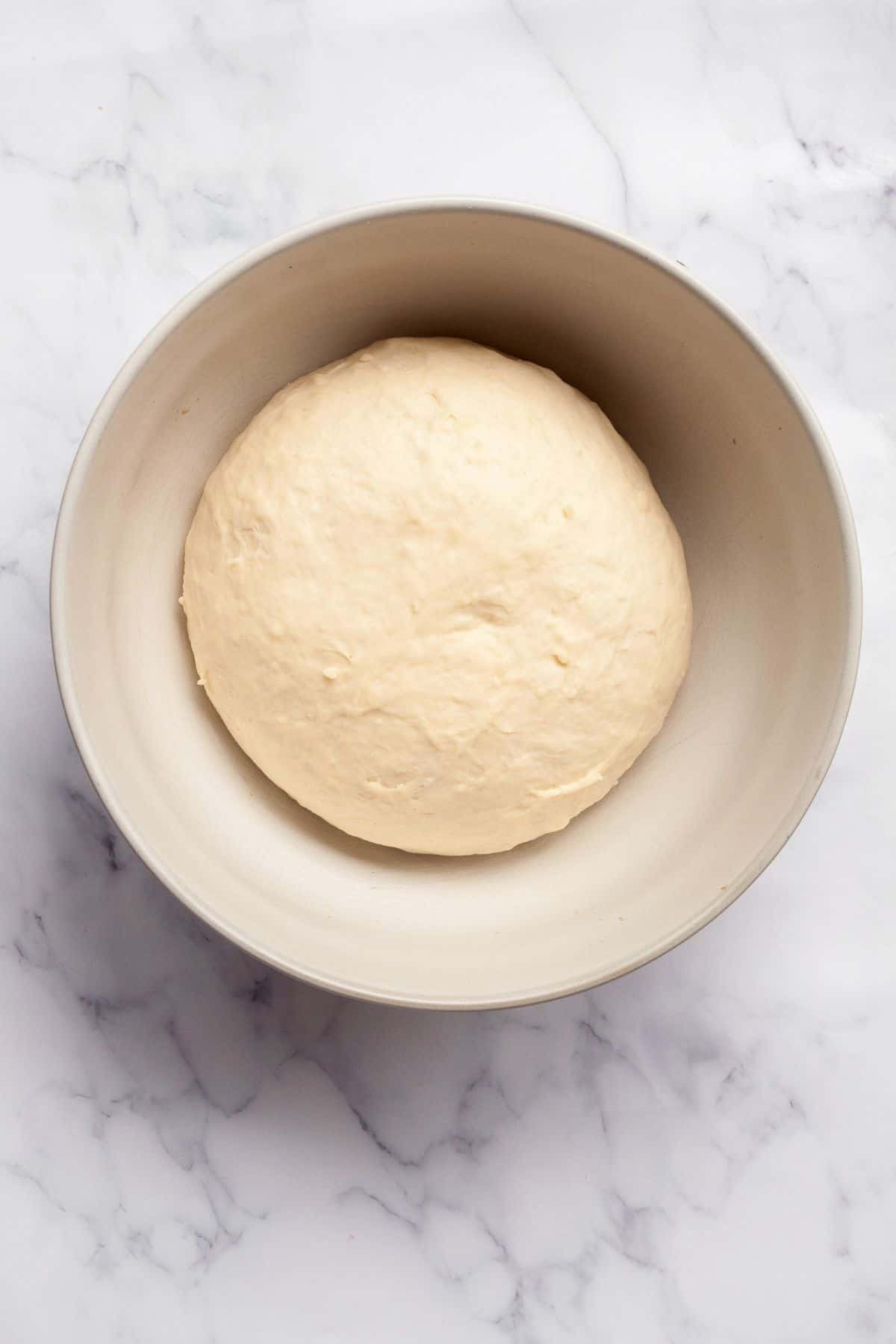 Homemade vegan dough after proofing and doubling in size.