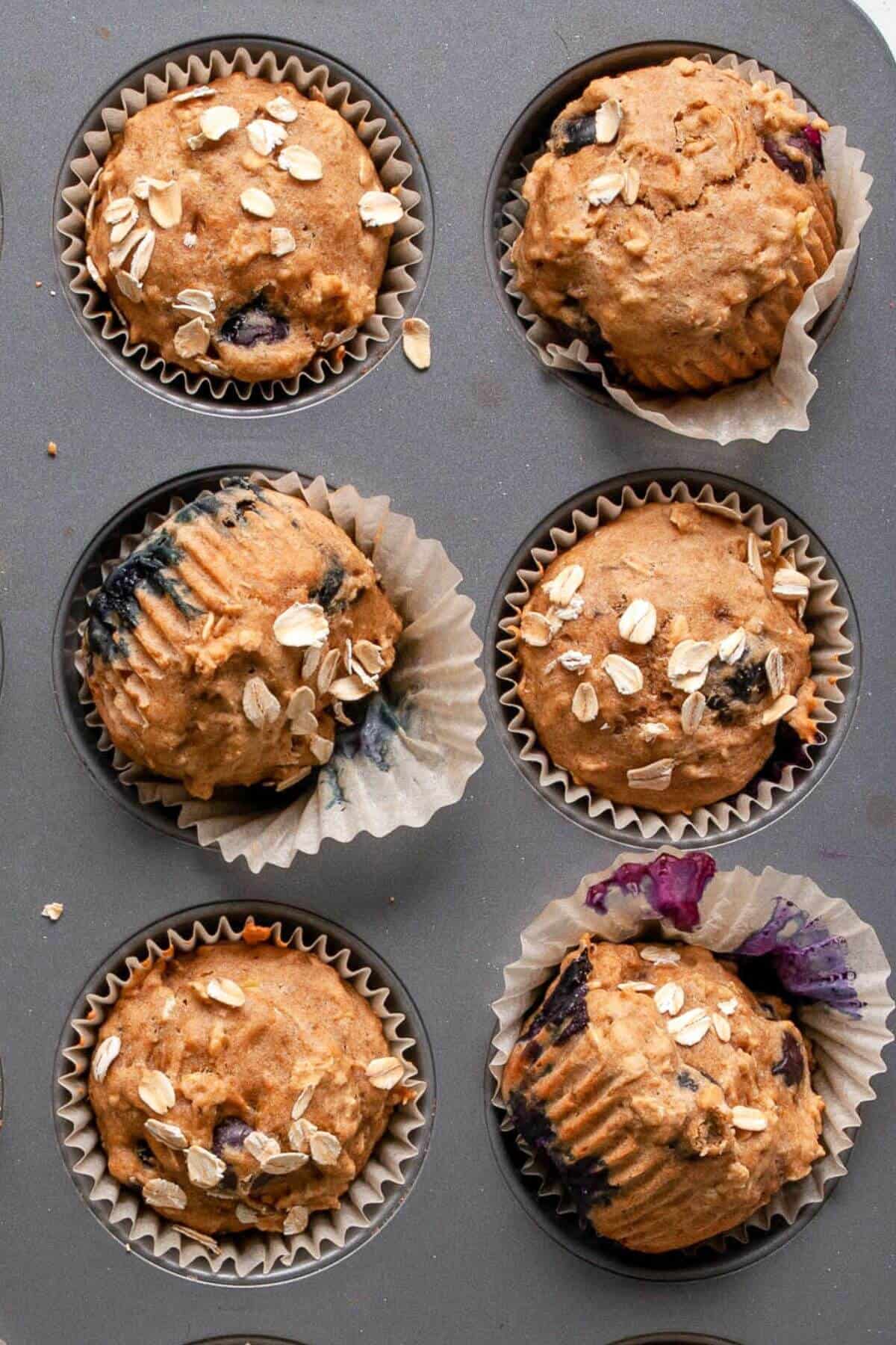 Close up of healthy blueberry banana oatmeal muffins made with oat flour in white muffin liners