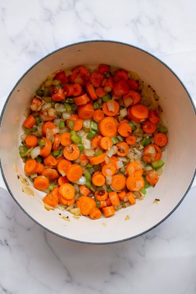 adding carrot rounds to the pot