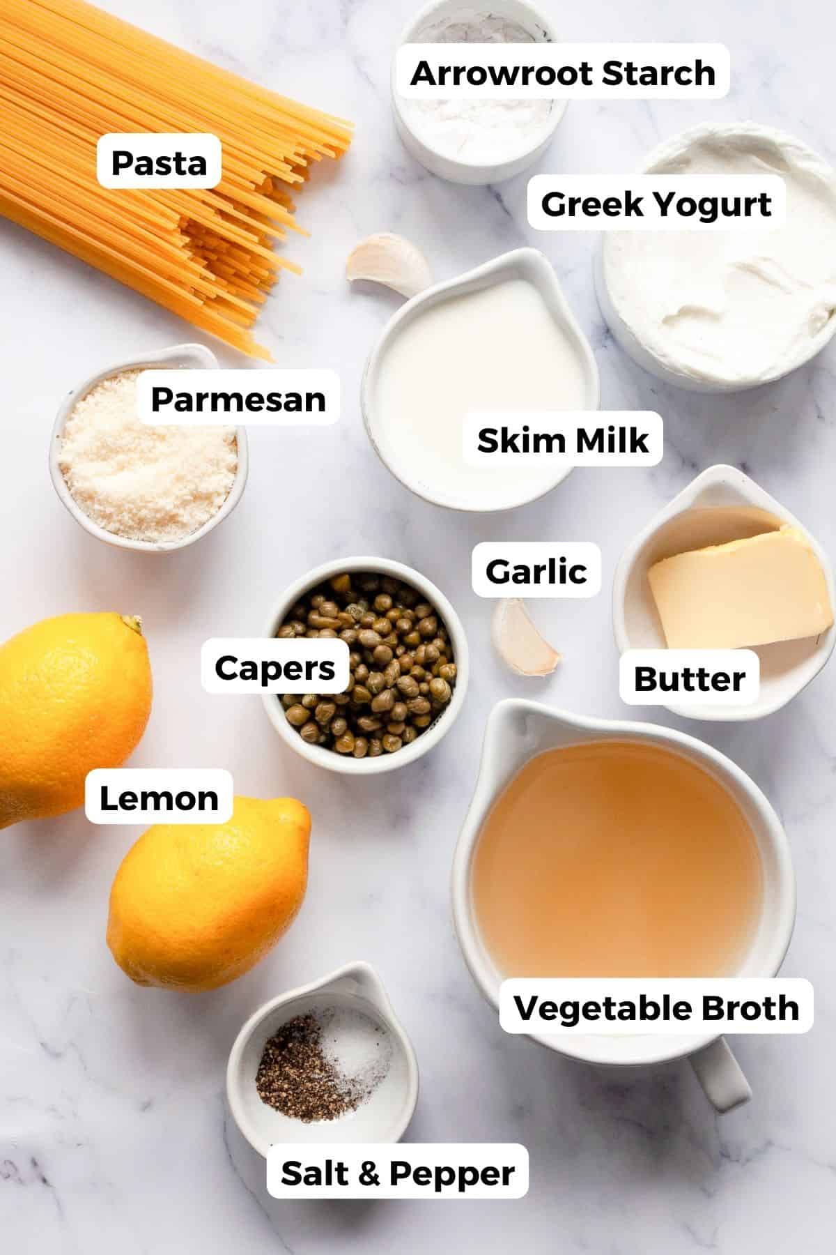 Ingredients for creamy lemon caper pasta including spaghetti, Greek yogurt, capers, lemon, garlic, and parmesan.