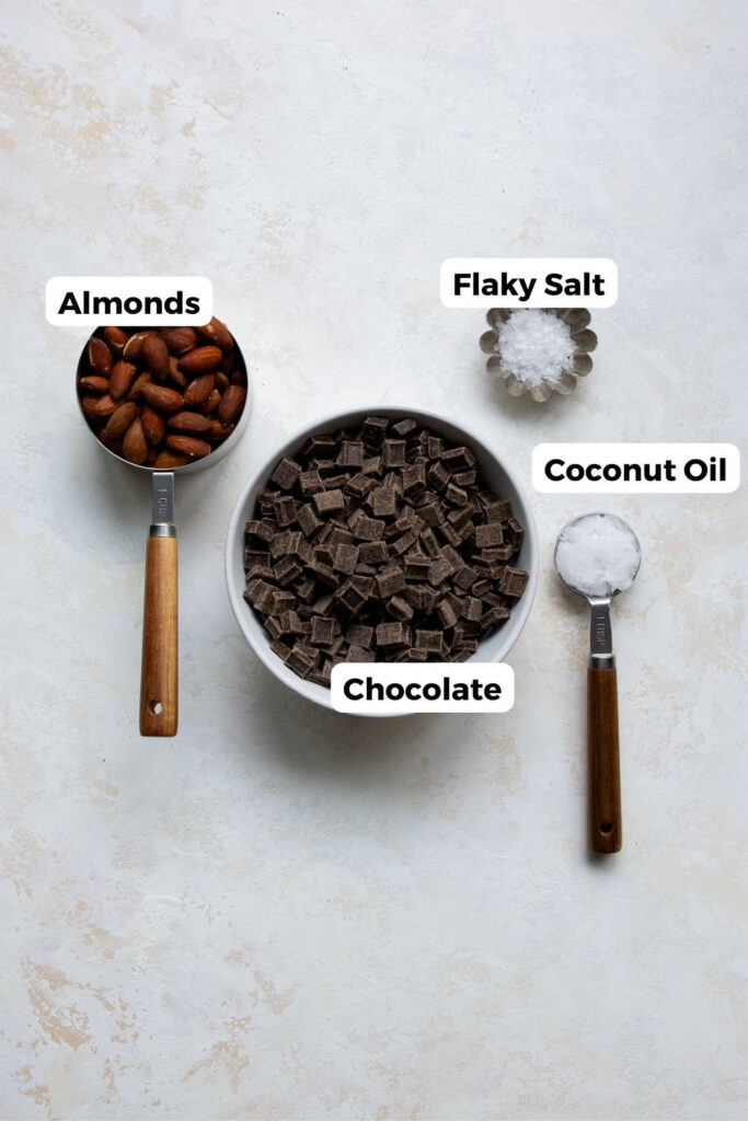all ingredients in almond bark in small bowls with labels