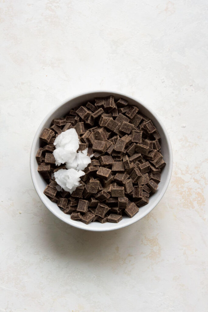 chocolate chips and solid coconut oil in a mixing bowl