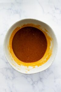 whisked pumpkin puree, eggs, ample syrup, vanilla, and coconut sugar in a mixing bowl