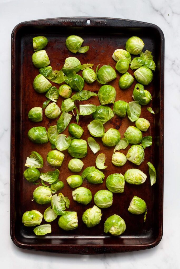 seasoned Brussel sprouts on a baking sheet before baking