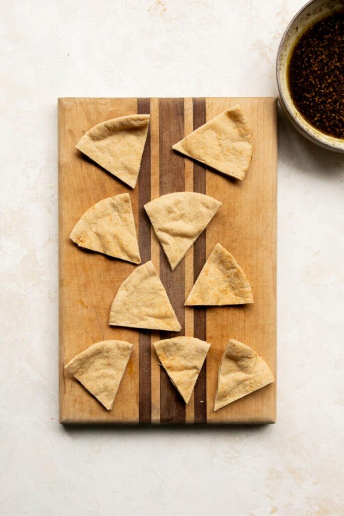pita bread triangles on a cutting board